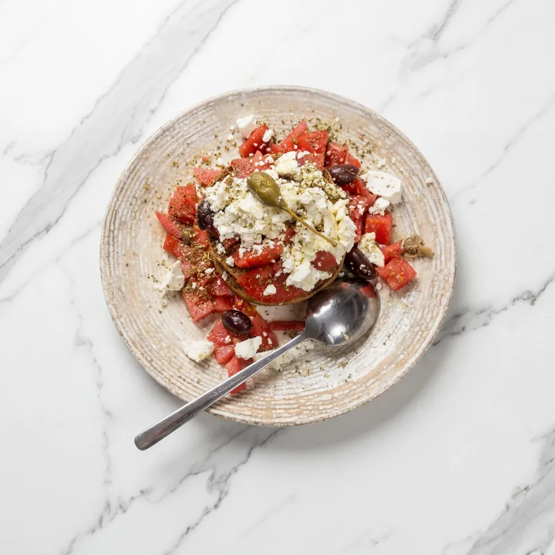 Cretan dakos topped with fresh tomatoes