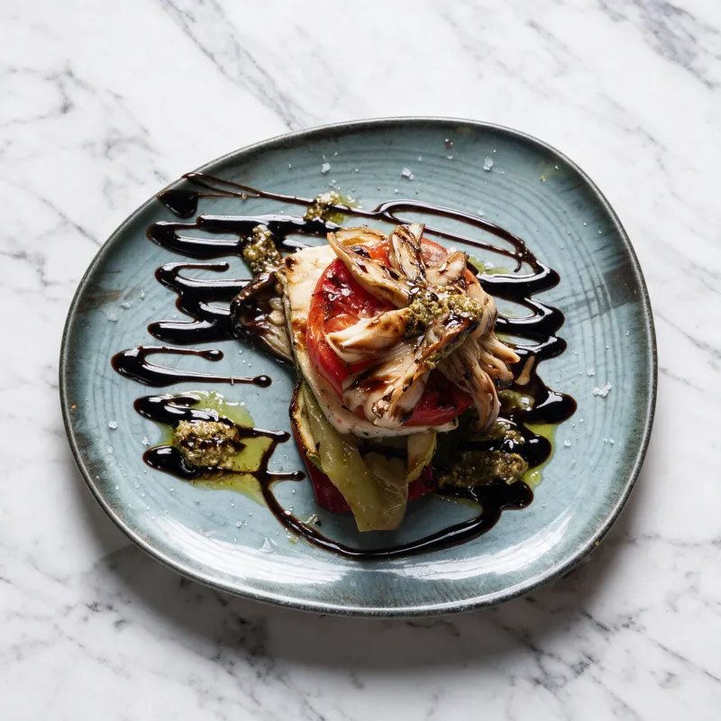 Layers of grilled vegetables topped with tender fish